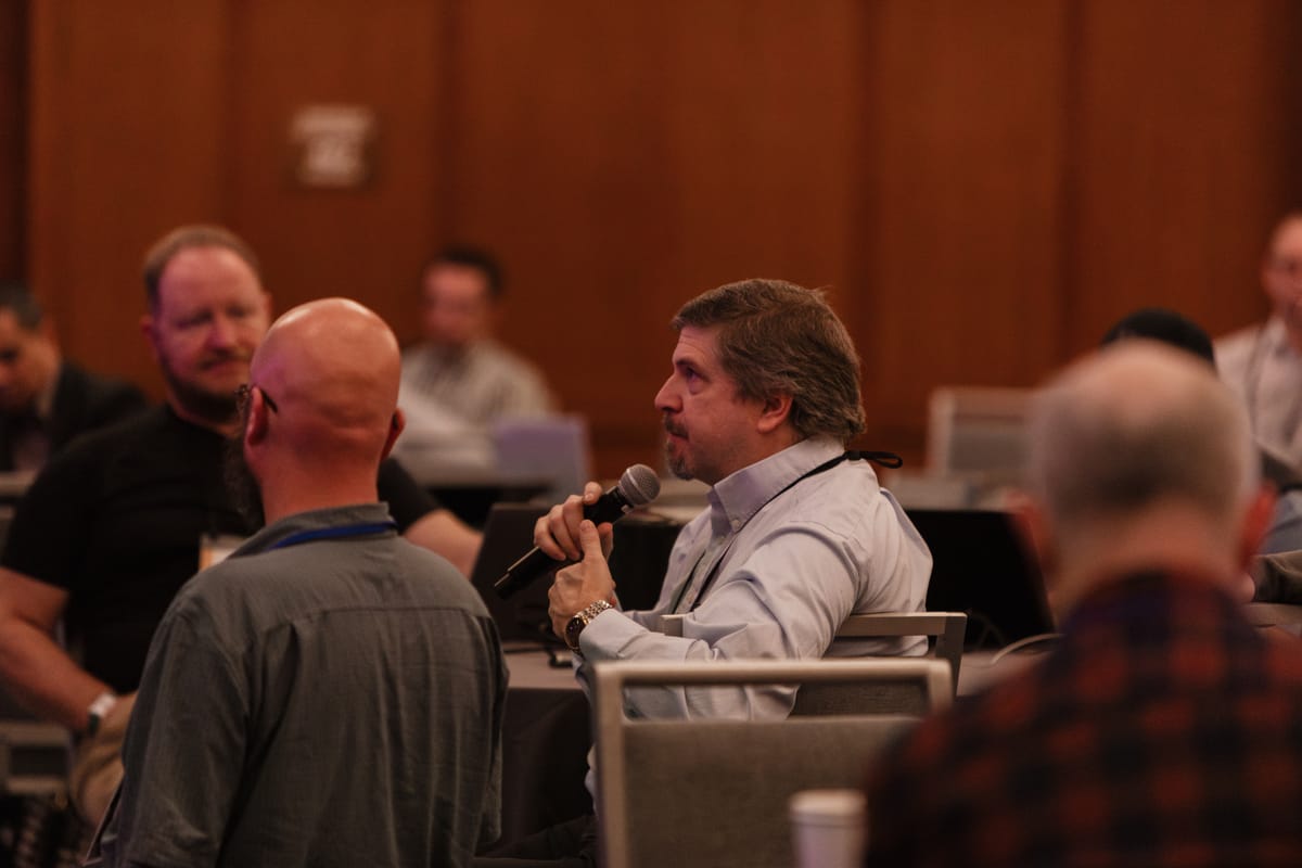 An attendee asks a question during a session at the ACCIS Fall 2025 Conference